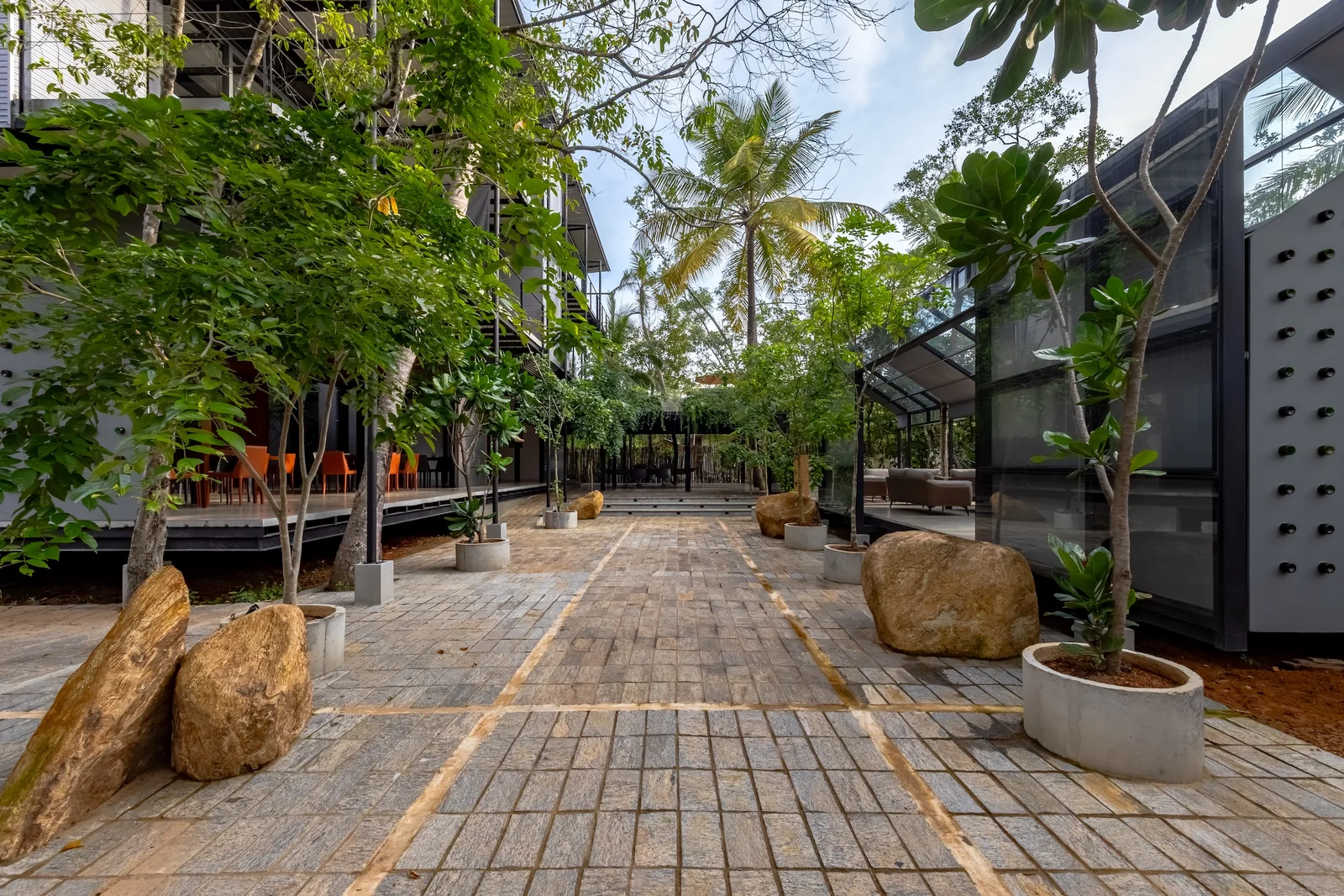 Boutique hotel facade and walkway integrated into the tropical landscape