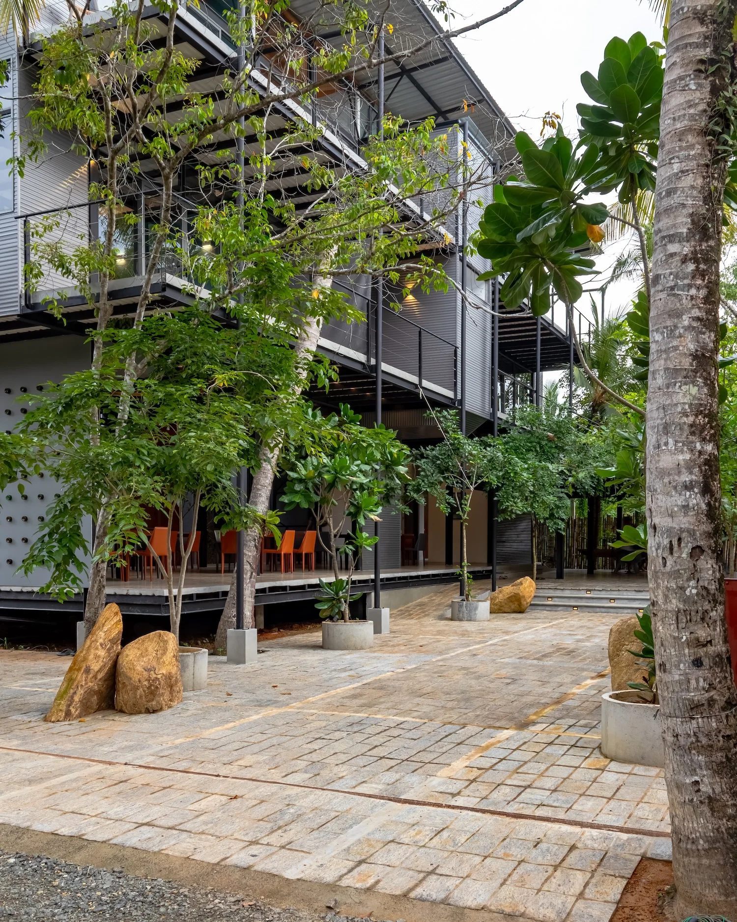 Sunlit exterior stair and elevated walkway detail at BlackRoots Unawatuna