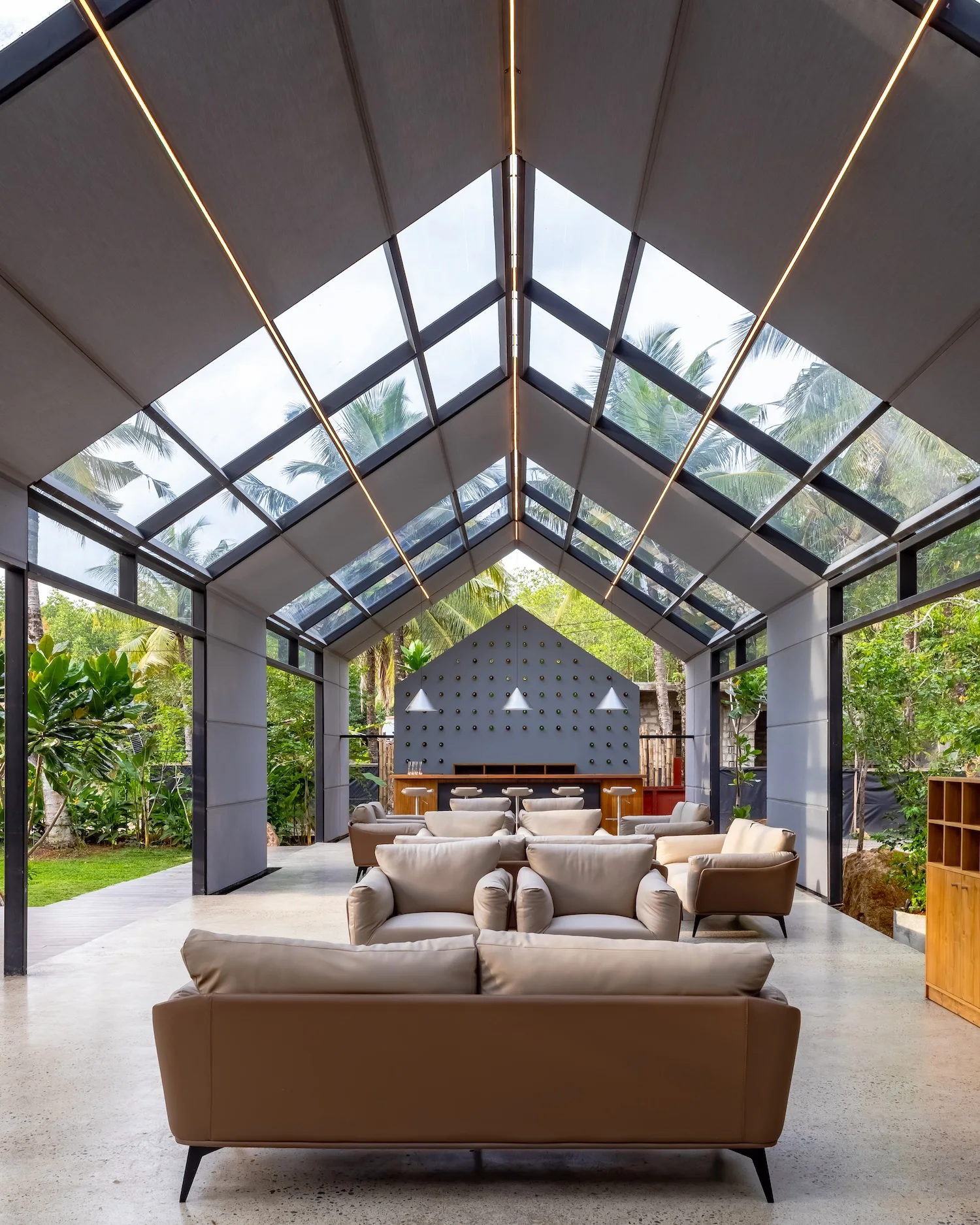Portrait lobby composition connecting open social space with garden views