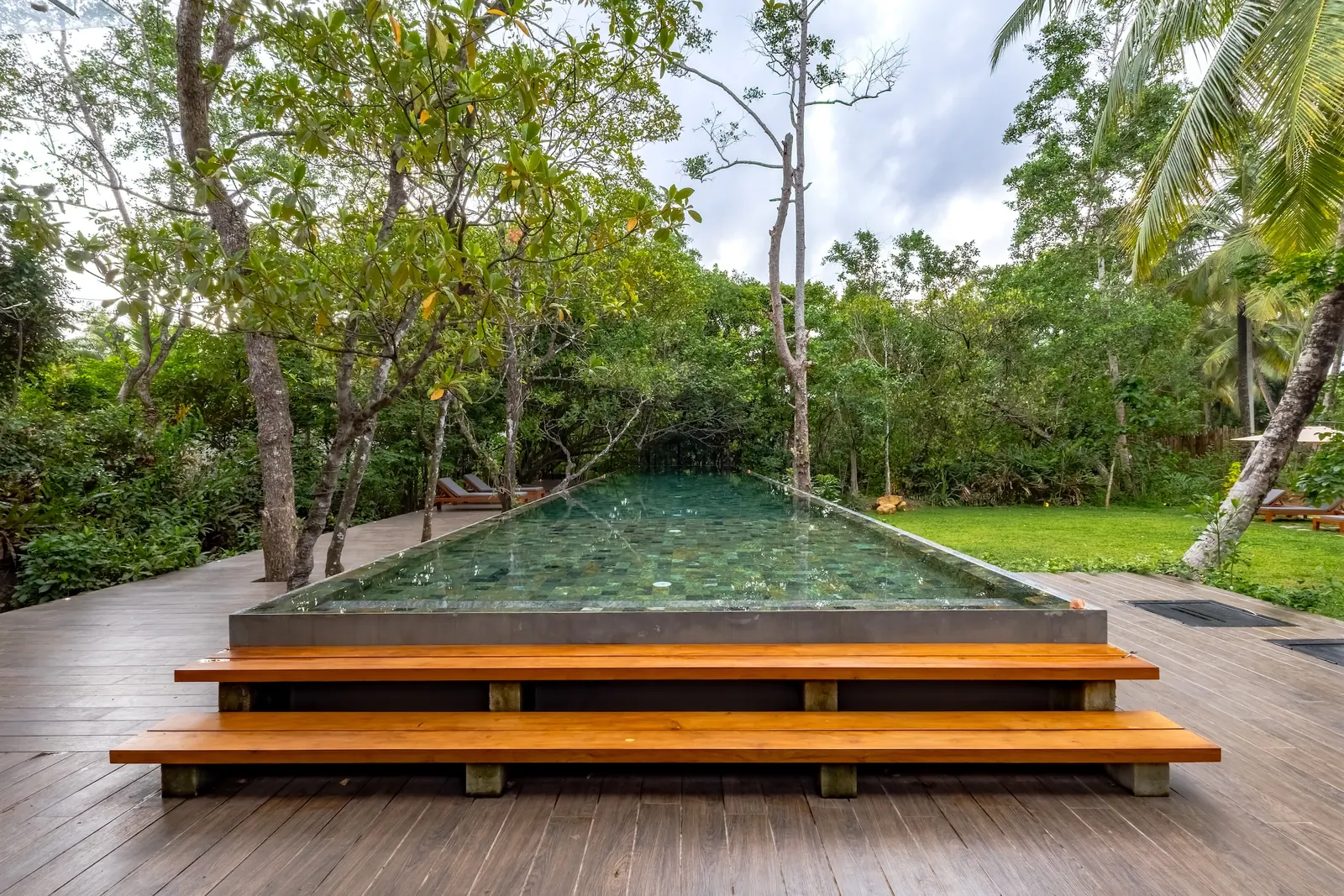 Infinity-edge pool immersed in tropical greenery at BlackRoots Unawatuna